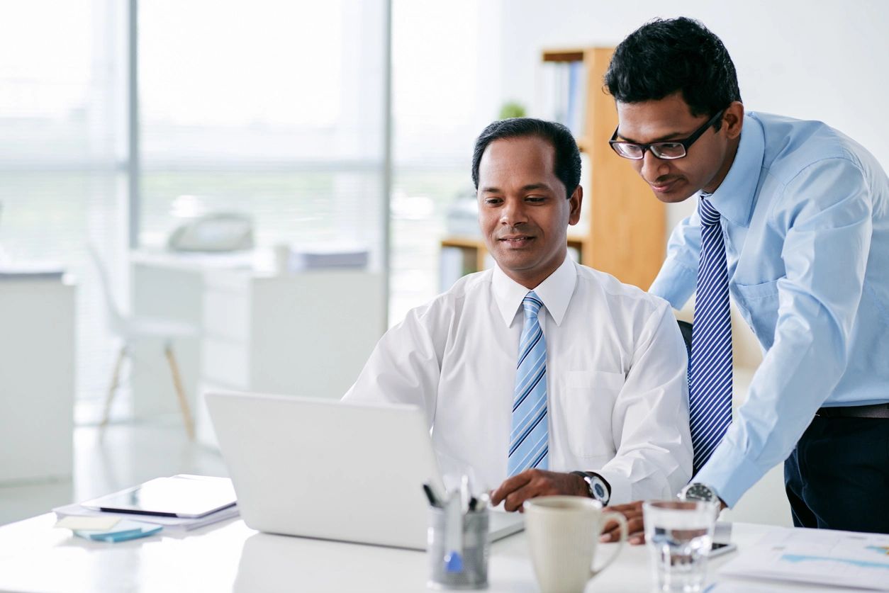 Two men reading sales funnel metrics